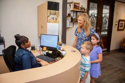 woman scheduling her next dental appointment at Mills Dental Group in Houston, TX