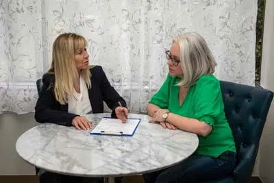 patient receiving her dental care plan at Mills Dental Group in Houston, TX